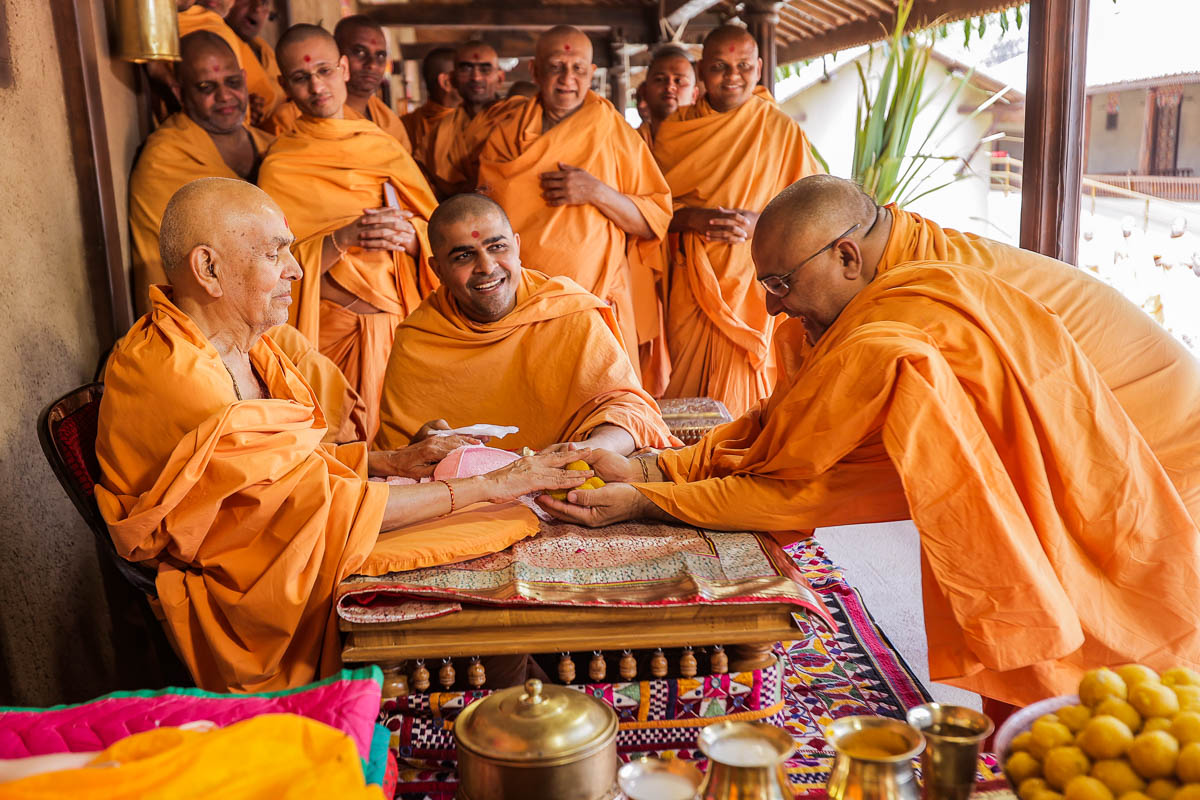 Swamishri gives prasad to Brahmacharan Swami
