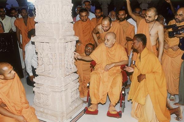   Swamishri observes the mandir and Shri Harikrishna Maharaj placed in the sinhasan of central shrine