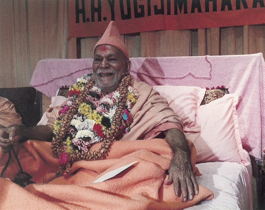 Yogiji Maharaj wearing garlands of flowers offered by devotees during the celebrations