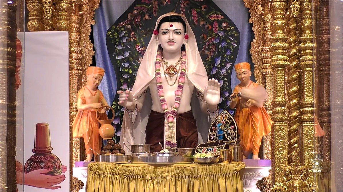 Ghanshyam Maharaj being offered lunchtime thal at London Mandir