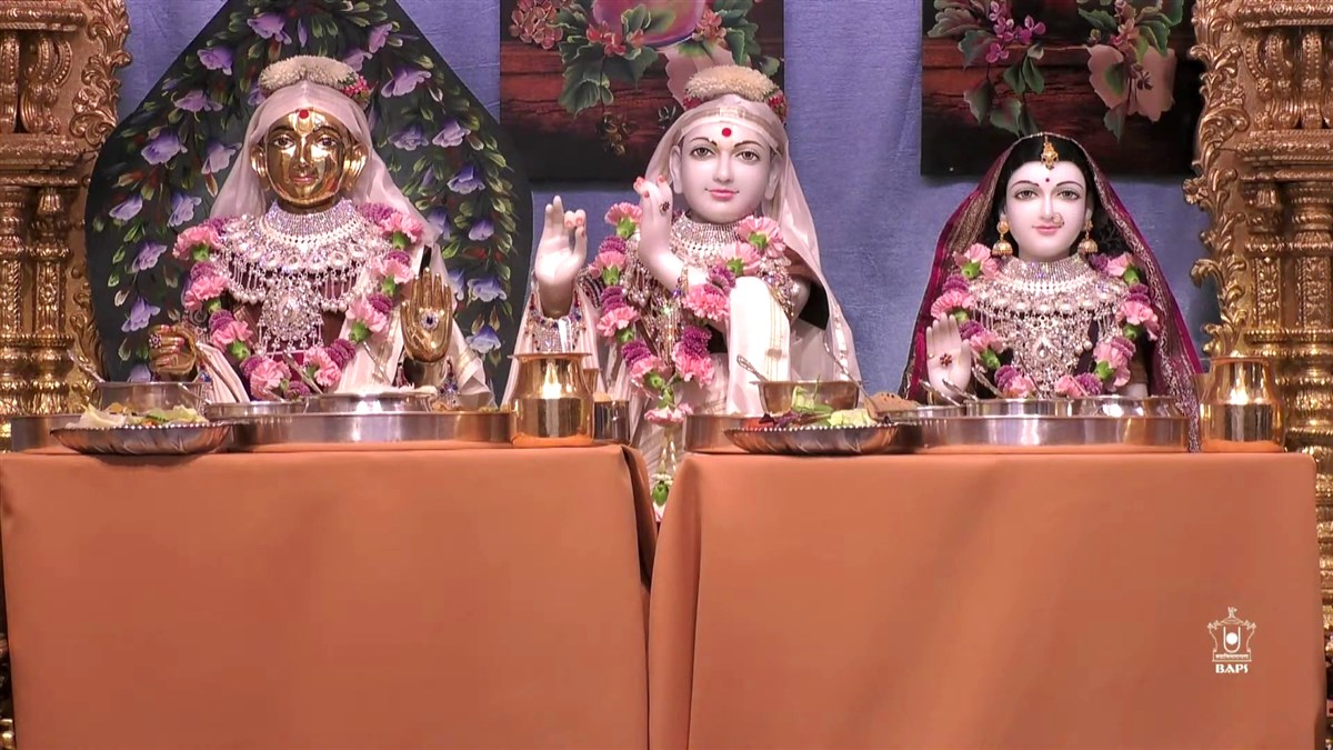 Harikrishna Maharaj and Shri Radha-Krishna being offered lunchtime thal at London Mandir