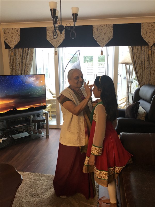 As per Hindu tradition, mahila devotees apply a kumkum chandlo on each other's foreheads to welcome one another to the virtual celebrations