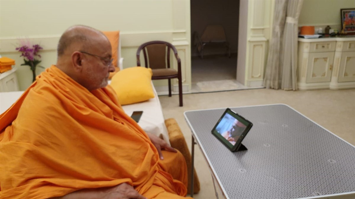 Sadguru Pujya Ishwarcharandas Swami watching the live webcast of the Calgary Shilanyas Vidhi