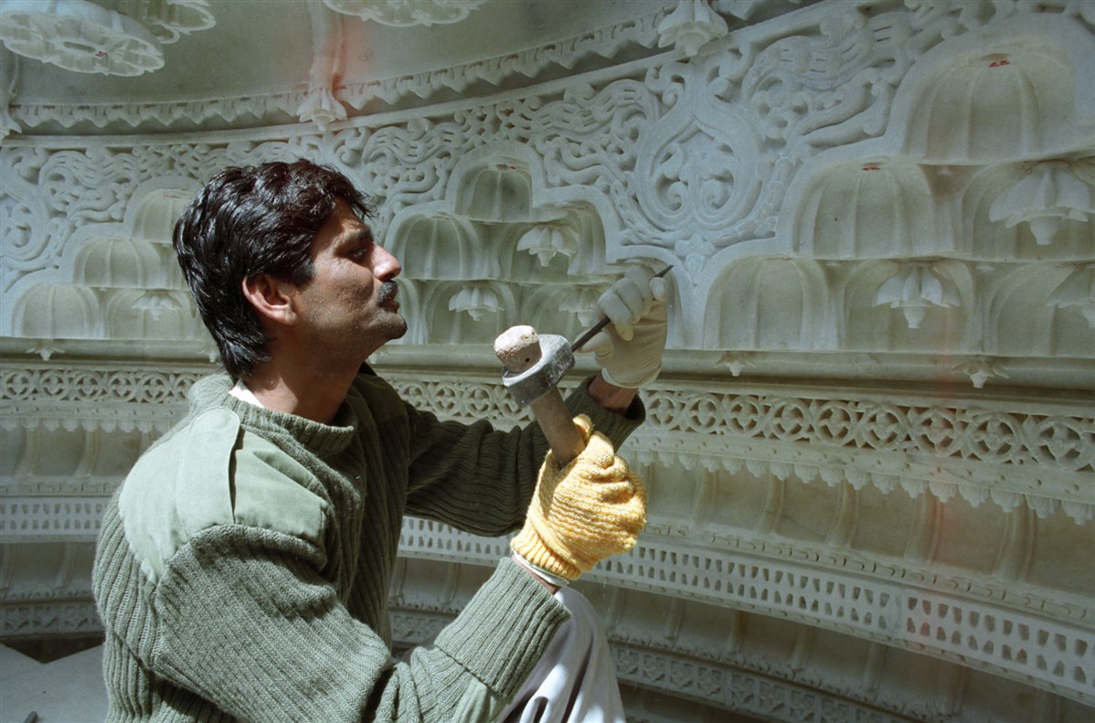 Around 100 artisans are brought over from India to assist in the stone carving in the UK, speeding up the process of construction