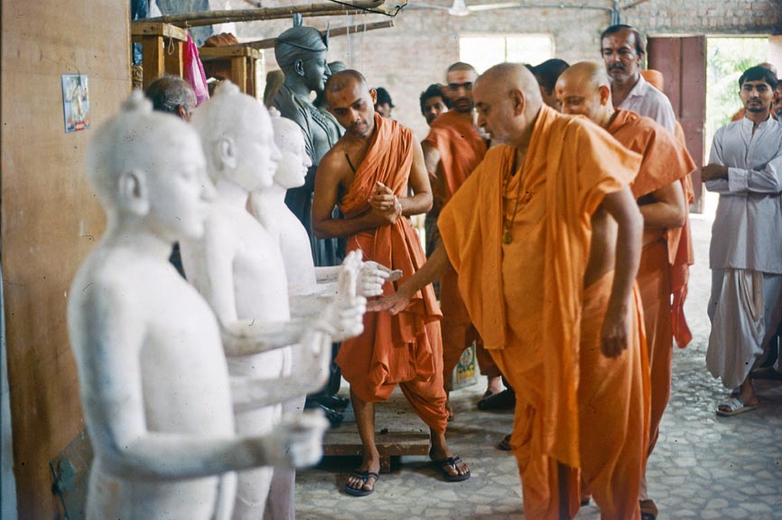 Pramukh Swami Maharaj was heavily involved in the design of the mandir. Here, he visits one of the stone carving workshops in India to assess the models of the murtis