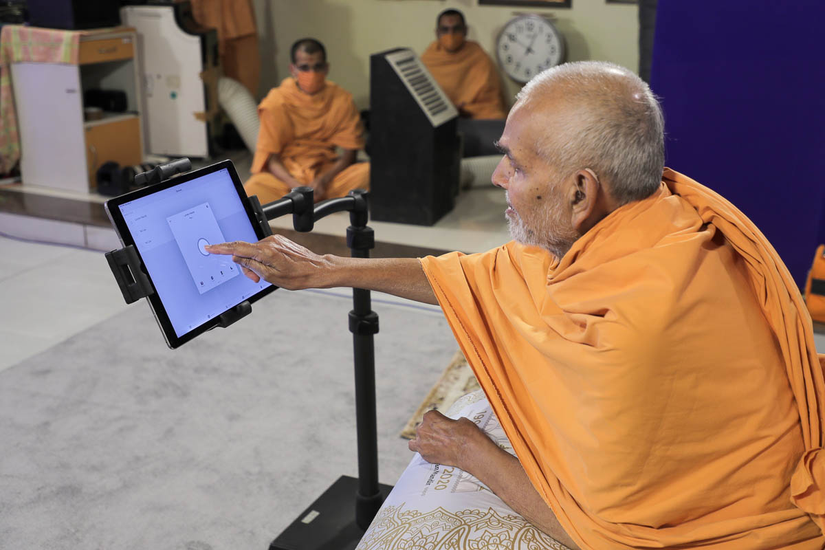 Mahant Swami Maharaj triggers a smart switch in Nenpur, India,...