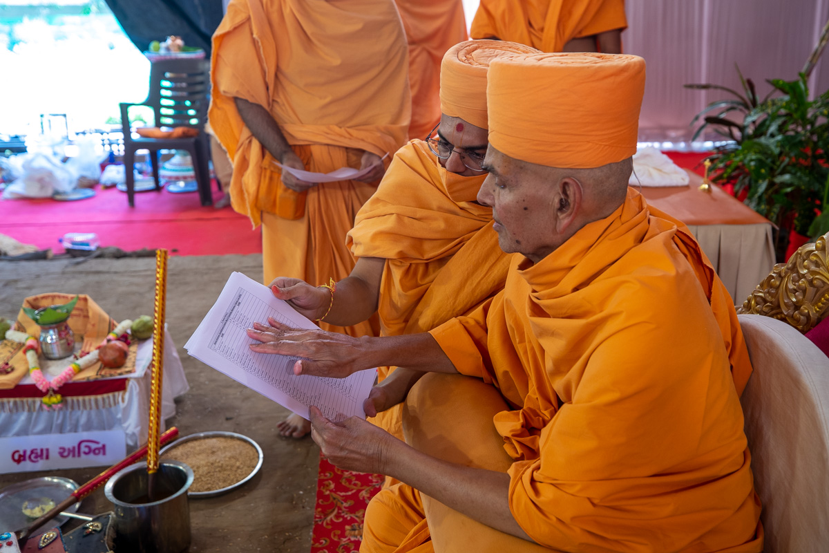 Swamishri blesses the list of yajmans