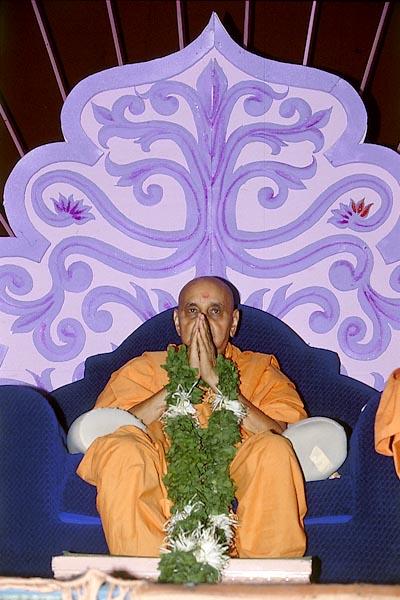  Swamishri is honored with a garland during the Guru Purnima festival