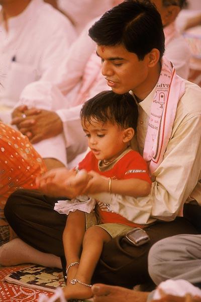  A child participates in the yagna rituals 