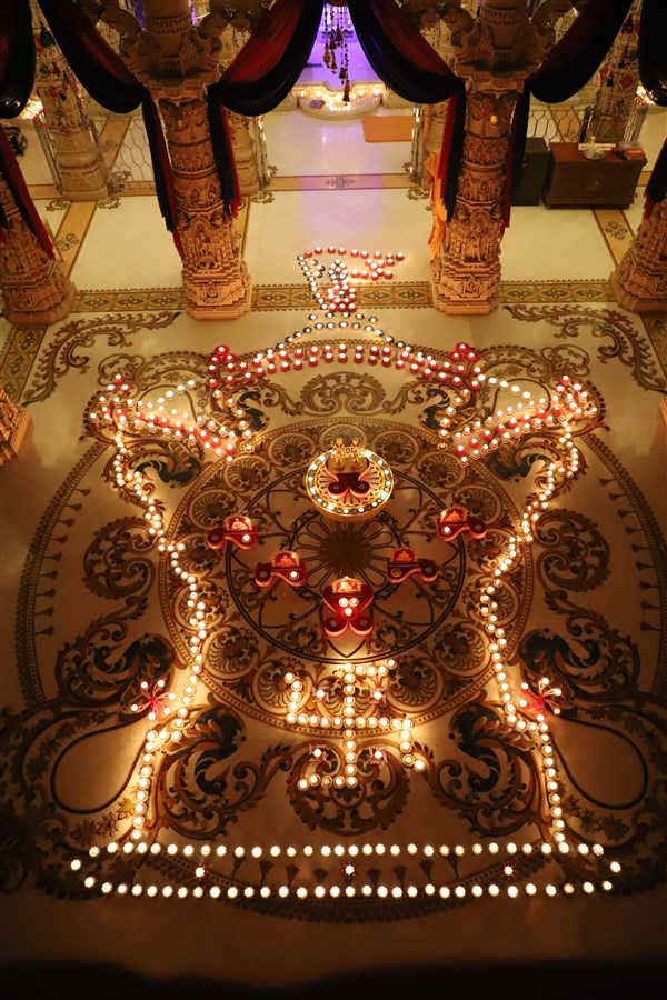 Aksharderi design using divas to commemorate Diwali
