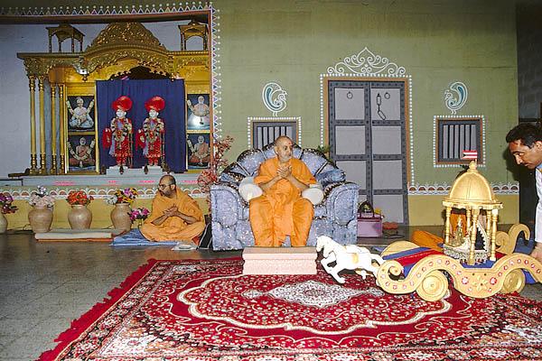  Swamishri presides over the symbolic celebration of Rath Yatra with Shri Harikrishna Maharaj in a decorated rath (chariot)