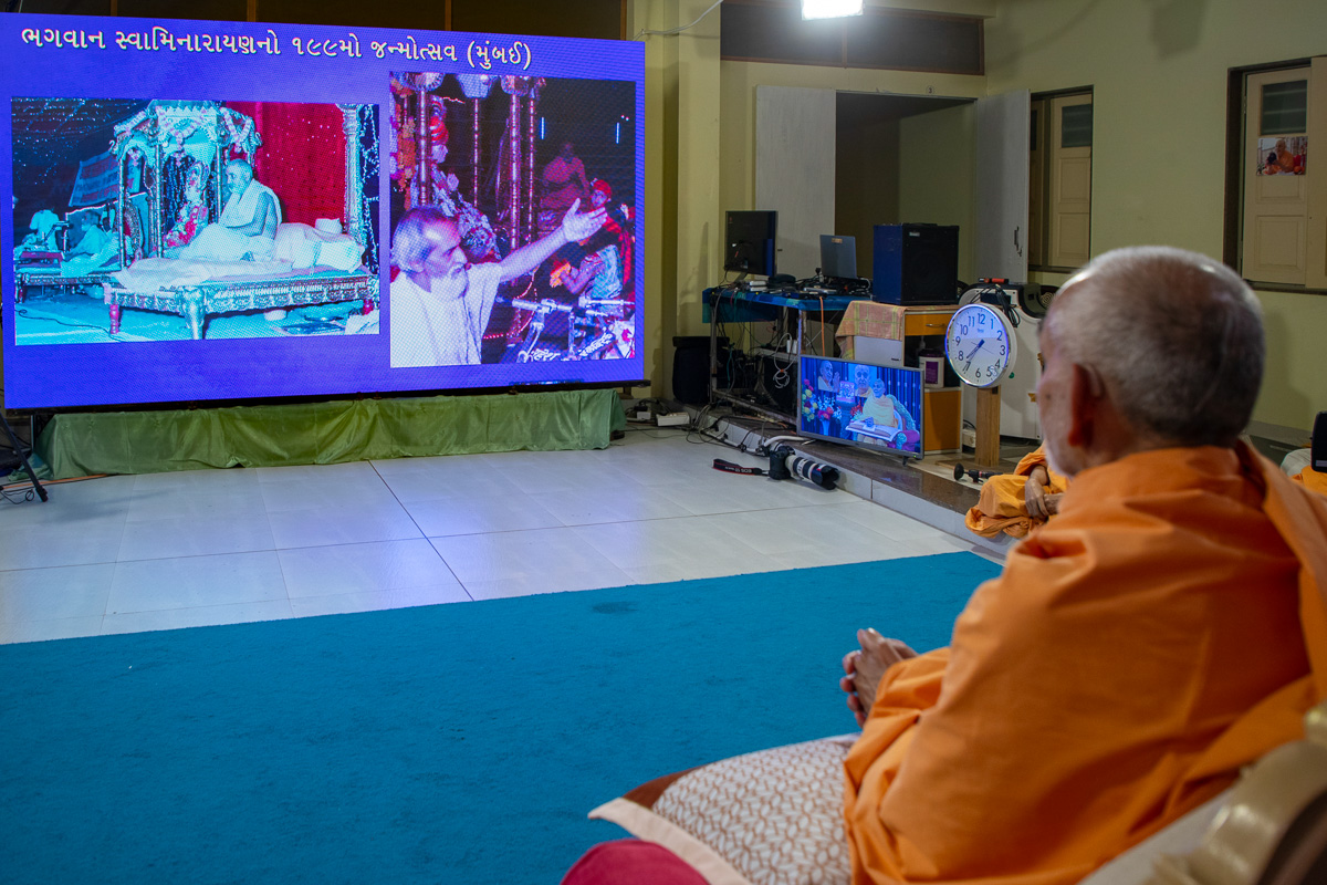 Swamishri watches a video on Pramukh Swami Maharaj
