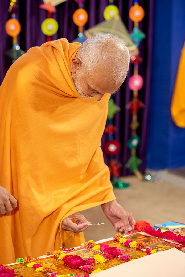 Swamishri places a small decorative kite