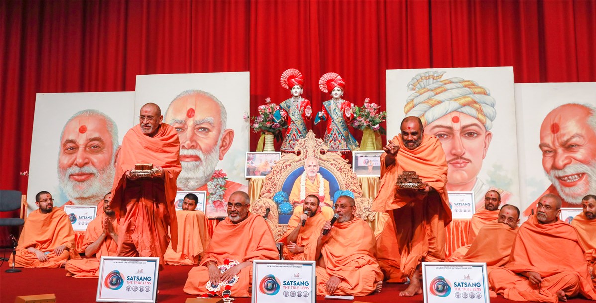Aksharviharidas Swami and Satyavratdas Swami offered sweets to Akshar-Purushottam Maharaj and Swamishri