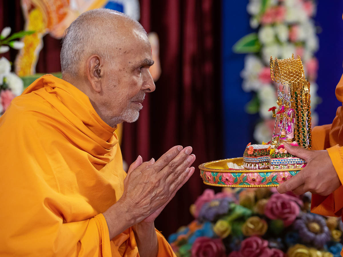 Swamishri engrossed in darshan of Shri Harikrishna Maharaj and Shri Gunatitanand Swami 