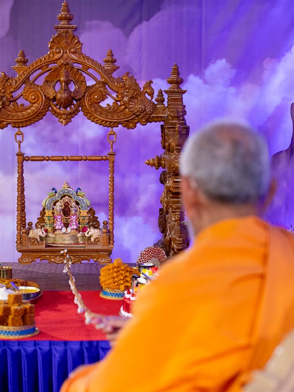 Swamishri swings Shri Harikrishna Maharaj and Shri Gunatitanand Swami in a hindolo
