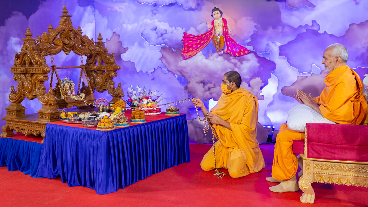 Shrutipriya Swami swings Shri Harikrishna Maharaj and Shri Gunatitanand Swami in a hindolo