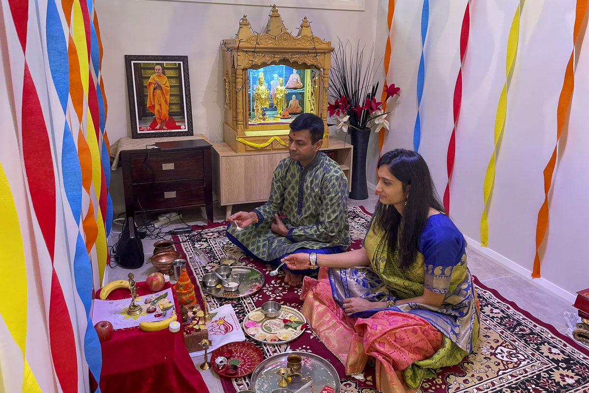 Devotees participate in the Groundbreaking Ceremony rituals from home