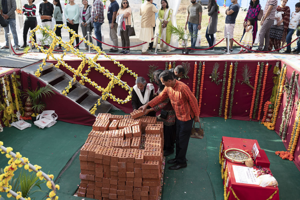 Devotees Place Their Worshiped Bricks