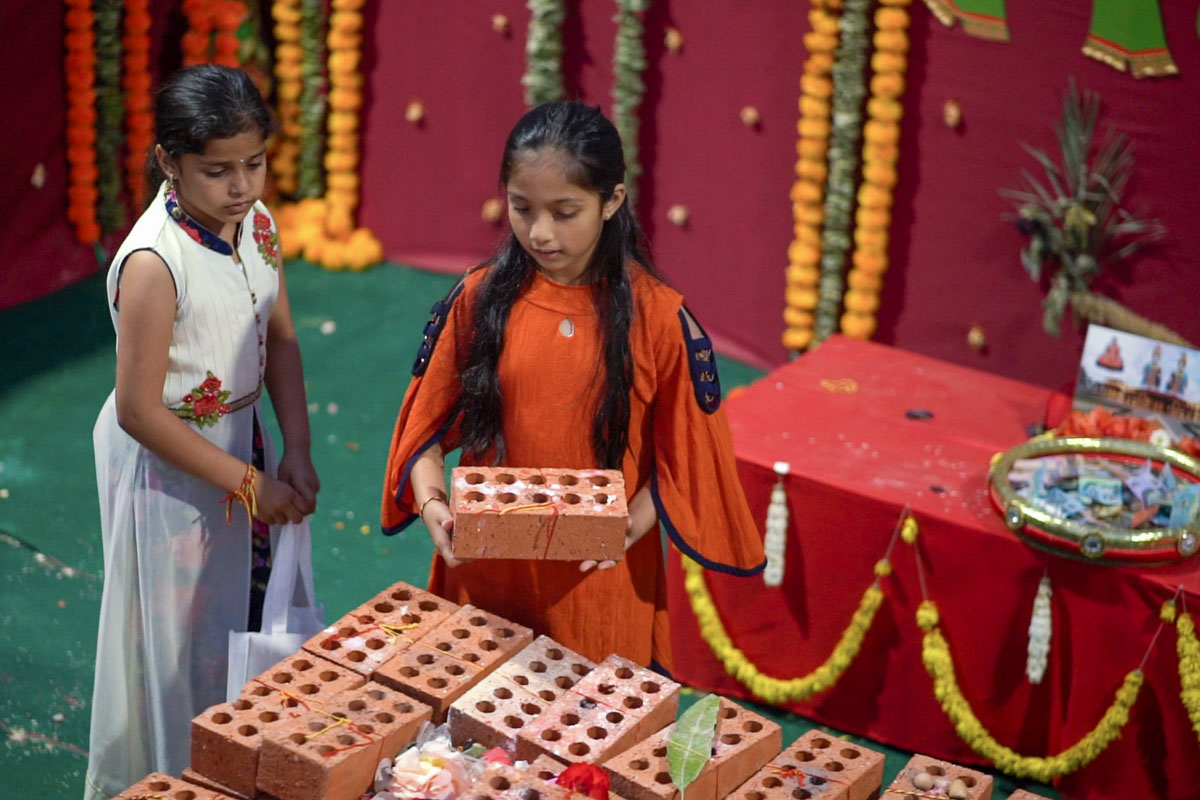 Devotees Place Their Worshiped Bricks