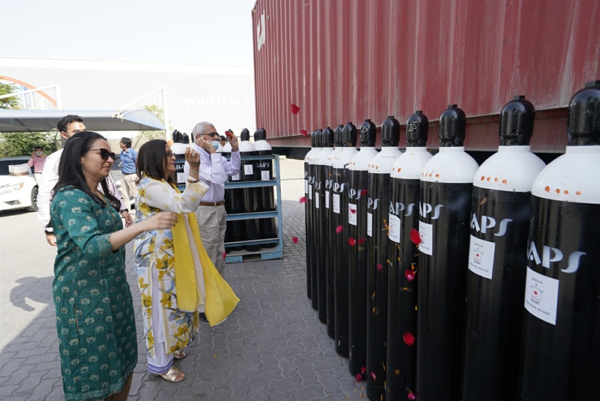 The Menda family doing pujan of Oxygen Cylinders