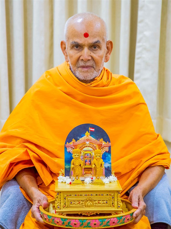 Swamishri with Shri Harikrishna Maharaj and Shri Gunatitanand Swami adorned in chandan garments