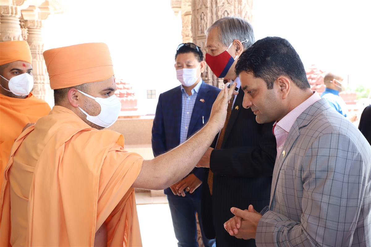 Pujya Divyacharandas Swami (Head Swami, BAPS Shri Swaminarayan Mandir, Los Angeles) welcomes Mr. Rishi Dhakal (Honorary Consul General of Nepal - Los Angeles) in a traditional manner