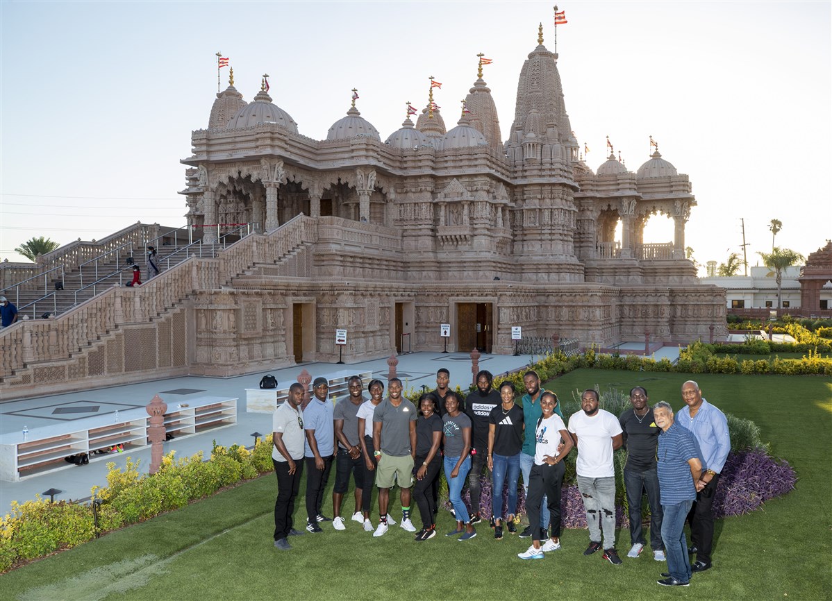 Group photo of the Jamaican sprinter and Olympian Yohan Blake and members Jamaican Olympic Track team in front of the BAPS Shri Swaminarayan Mandir in Los Angeles, CA