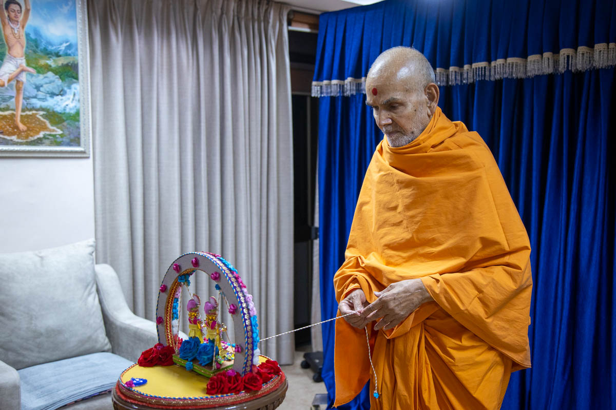 Swamishri swings Shri Harikrishna Maharaj and Shri Gunatitanand Swami on a hindolo in the evening