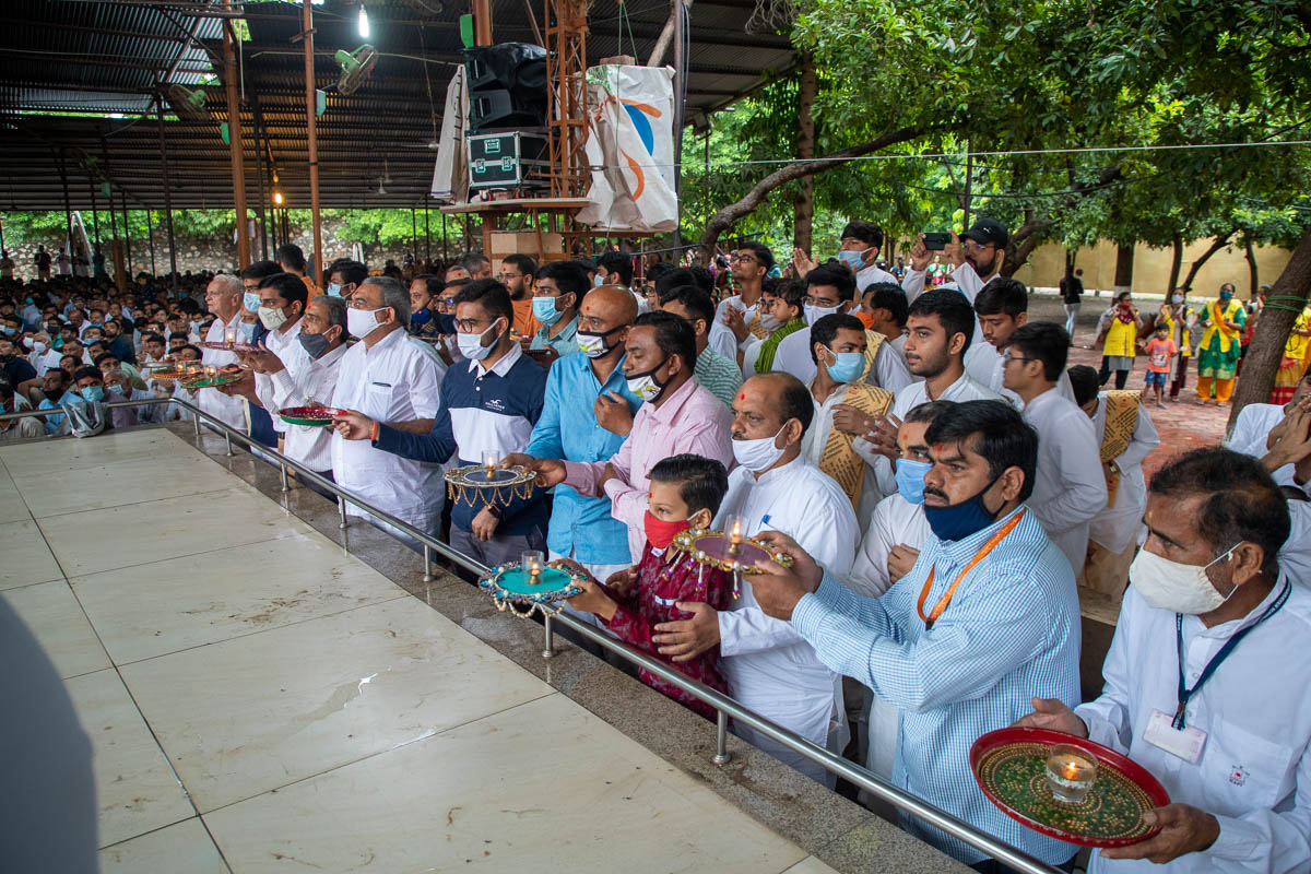 Devotees perform the celebration arti