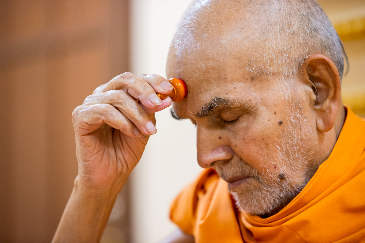 Swamishri applies a chandlo 