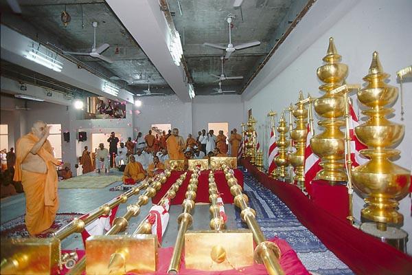  The mandir kalashas and flagstaffs arranged behind Swamishri's puja. Thereafter Swamishri performs pujan and arti    