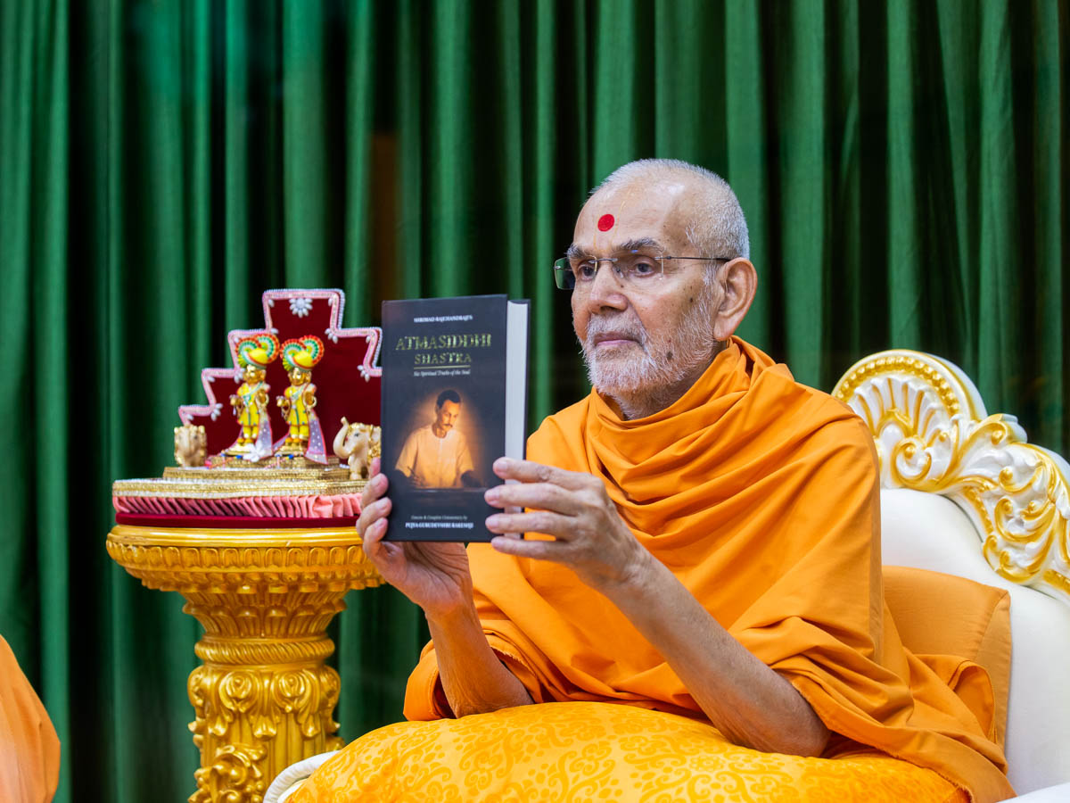 Swamishri sanctifies a book 'Atmasiddhi Shastra'