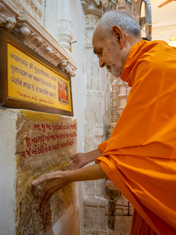 Swamishri engrossed in darshan of sacred stone