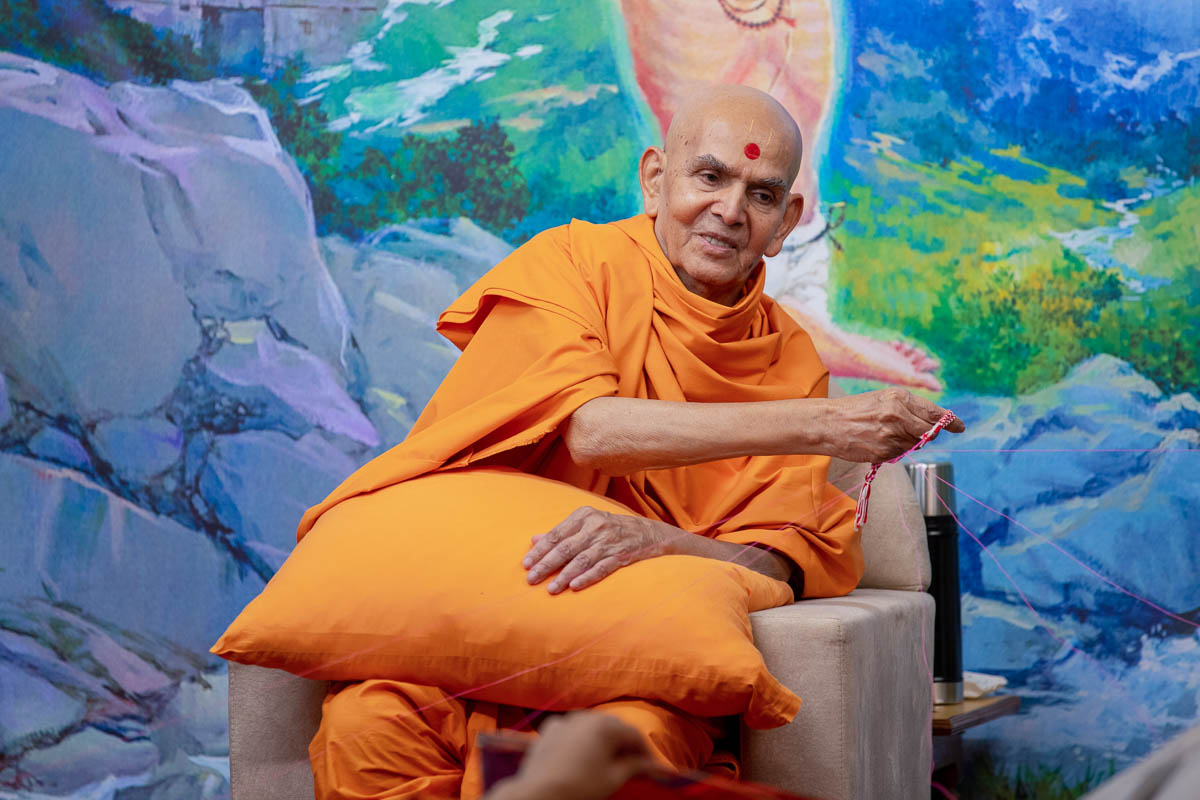 Swamishri participates in an activity during the evening