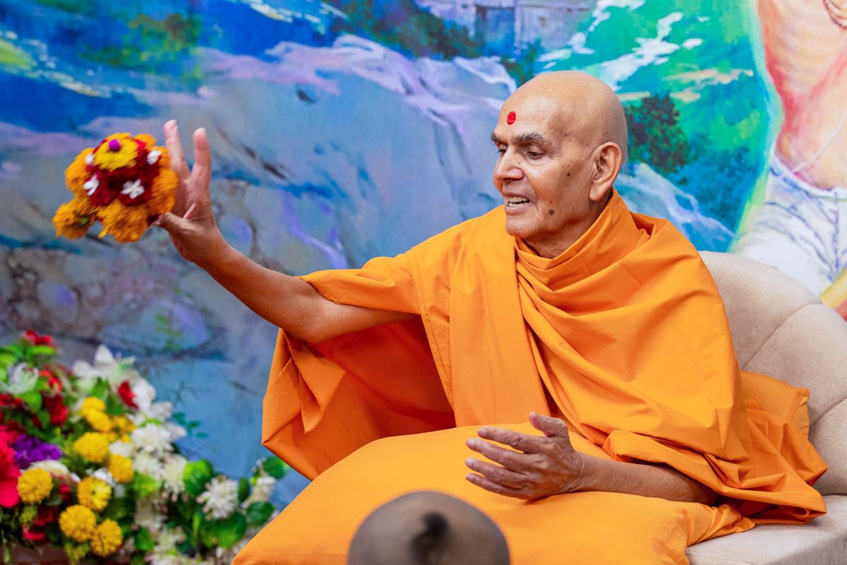 Swamishri participates in an activity 