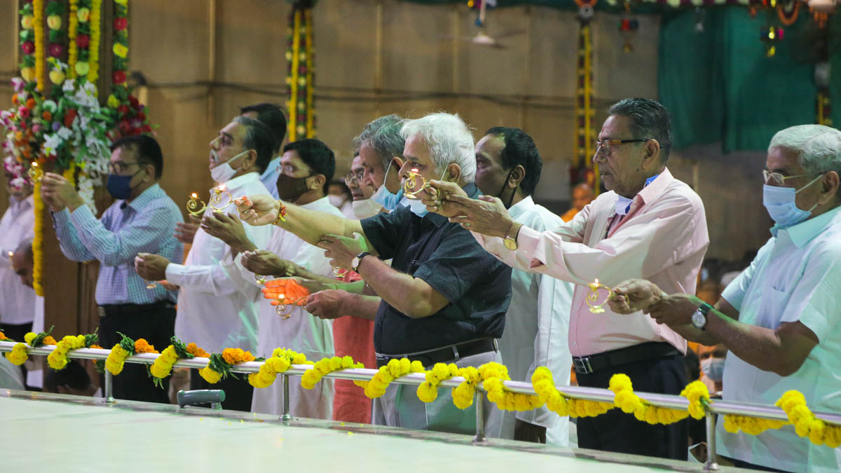 Devotees perform arti during the celebration