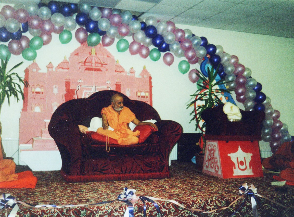 Pramukh Swami Maharaj listening attentively during an assembly in Ashton-under-Lyne, in 1994