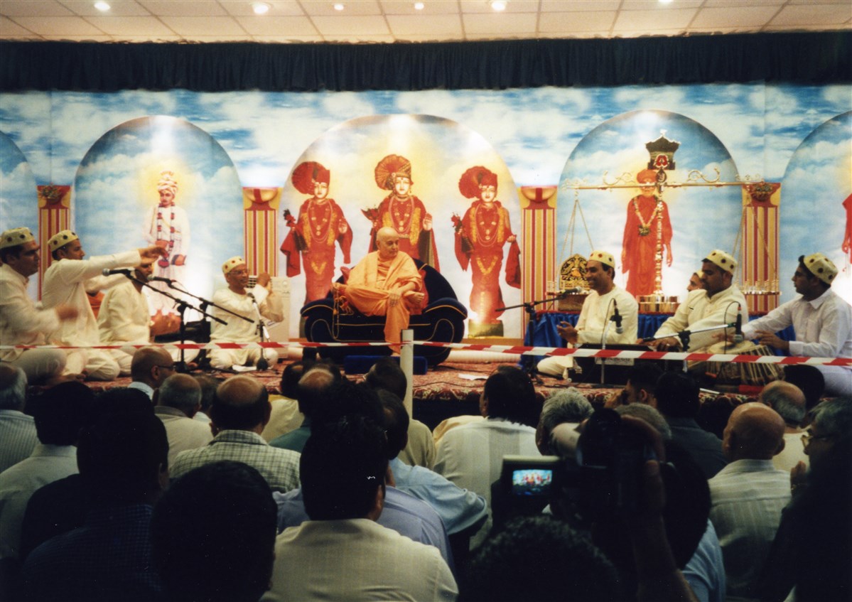 Youths devoutly performed a bhajan before Pramukh Swami Maharaj in an assembly during his stay in 2000