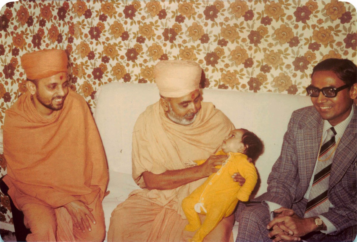 Pramukh Swami Maharaj blessing a child during his visit in 1977