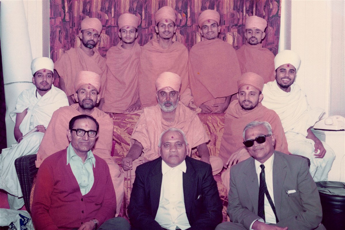 Pramukh Swami Maharaj, Mahant Swami and other swamis with some of the pioneering devotees of Birmingham Satsang Mandal during their visit in 1977