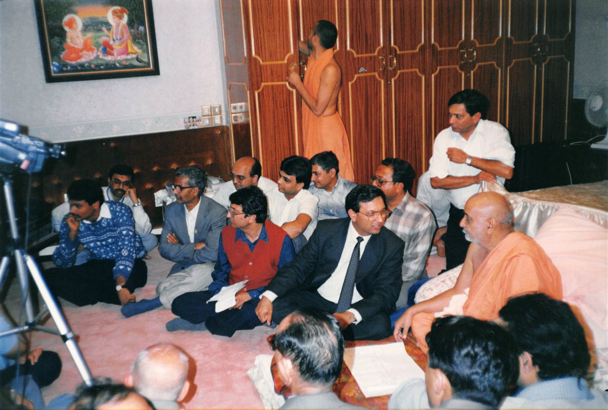 In London, in 1990, Pramukh Swami Maharaj discussed plans with volunteers for a new satsang bhavan in Birmingham