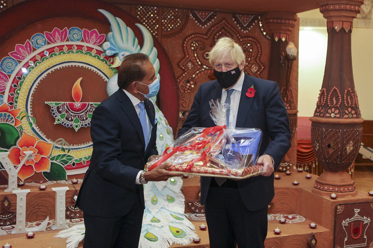 Jitu Patel, a BAPS trustee, presented the Prime Minister with some Diwali gifts, including something for his young son, Wilfred