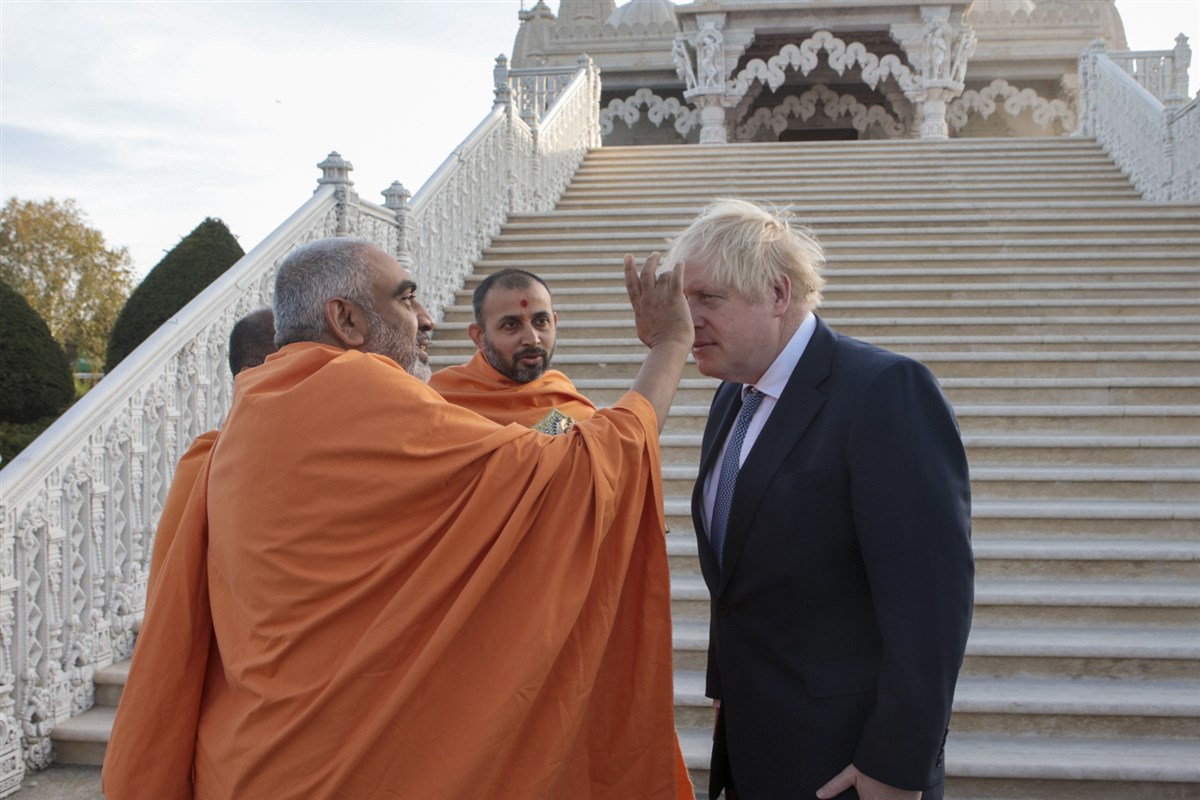 Prime Minister Boris Johnson was greeted in traditional Hindu manner by the head of the Mandir, Yogvivekdas Swami