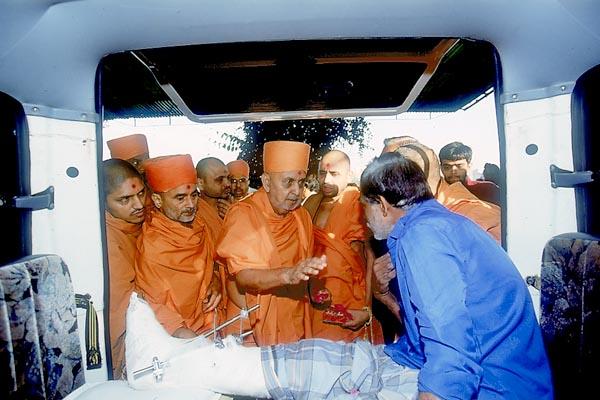  Swamishri blesses a devotee recovering from an accident