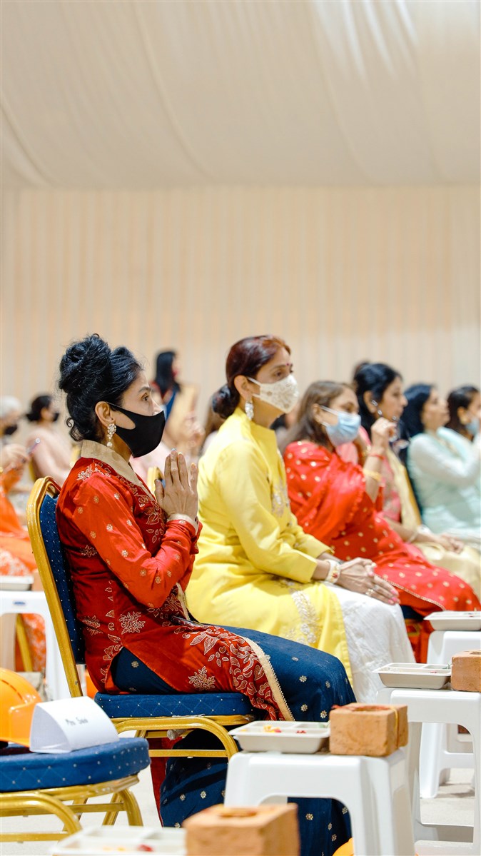 Women devotees participate in the puja and assembly