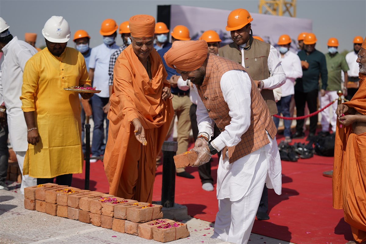 Balbir Singh Randhava places a sanctified brick