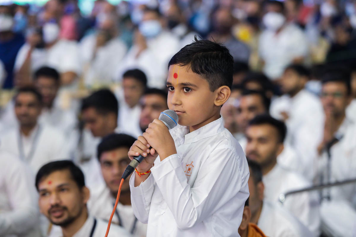 A child leads the recital of the daily prayers
