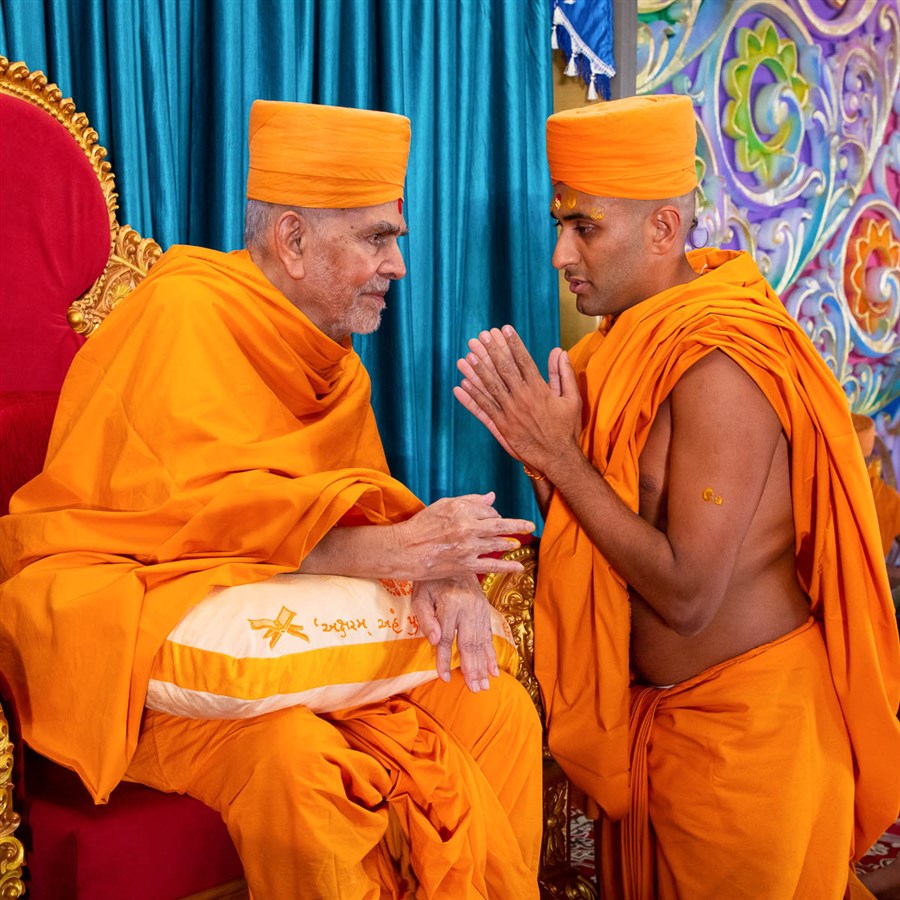 Swamishri gives diksha mantra and blessings to newly initiated sadhus