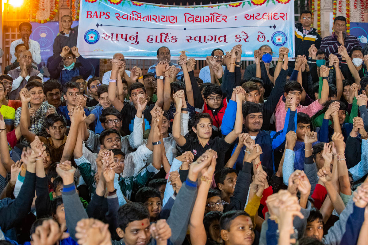 Students join hands in a gesture of unity